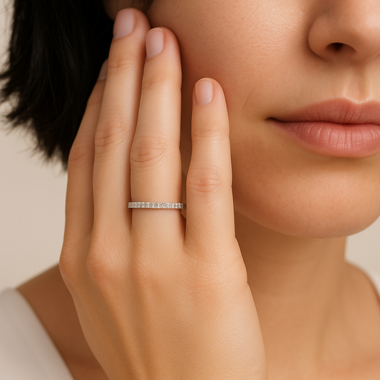 Close-up of a woman's hand wearing a silver ring with a blurred background
