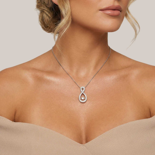Silver necklace with a pendant worn by a model against a neutral background