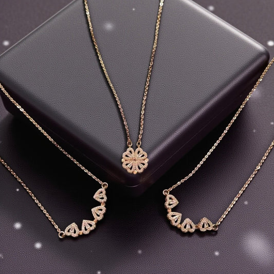 Three gold necklaces on a dark surface with a black box.