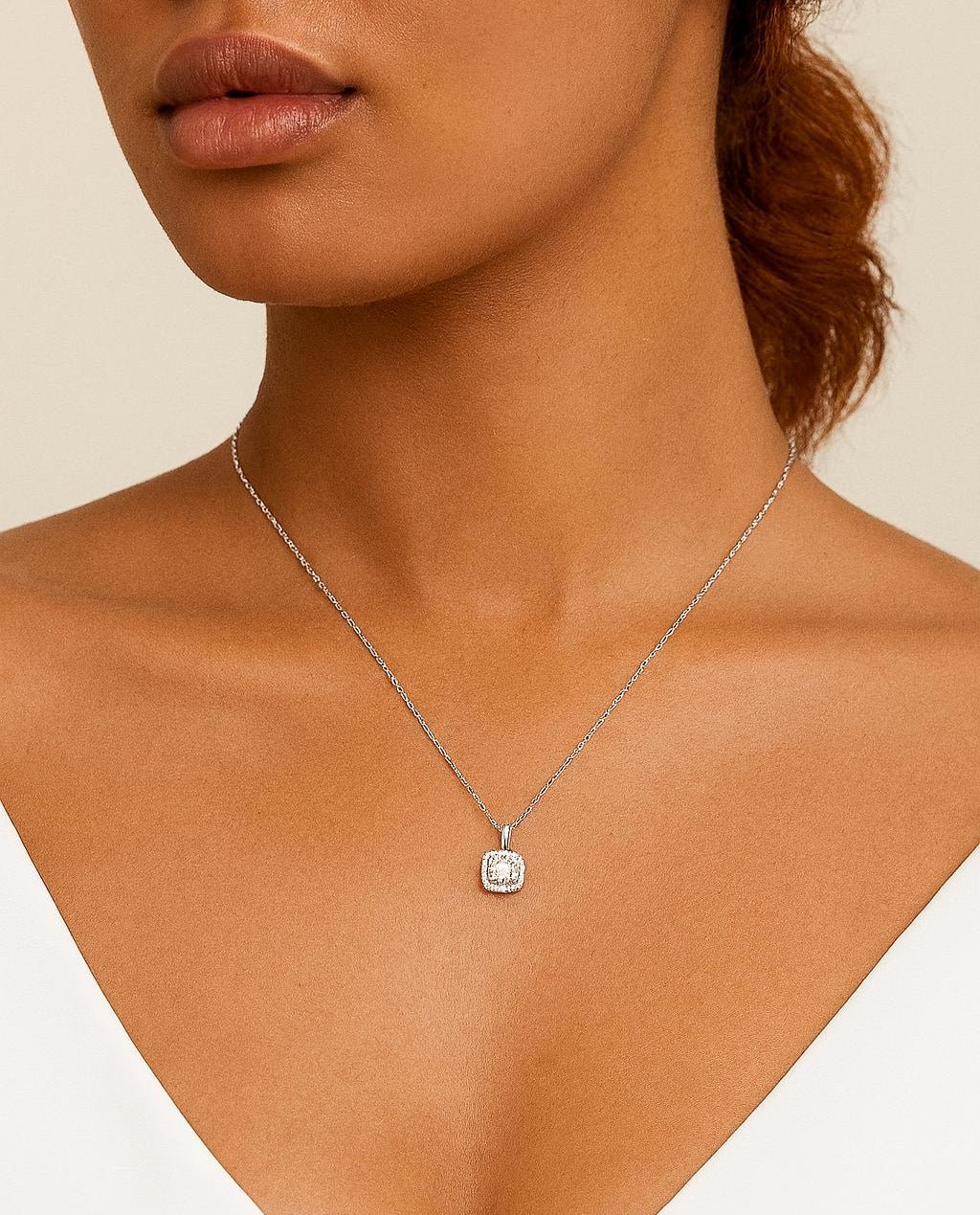 Necklace with a pendant on a model against a neutral background