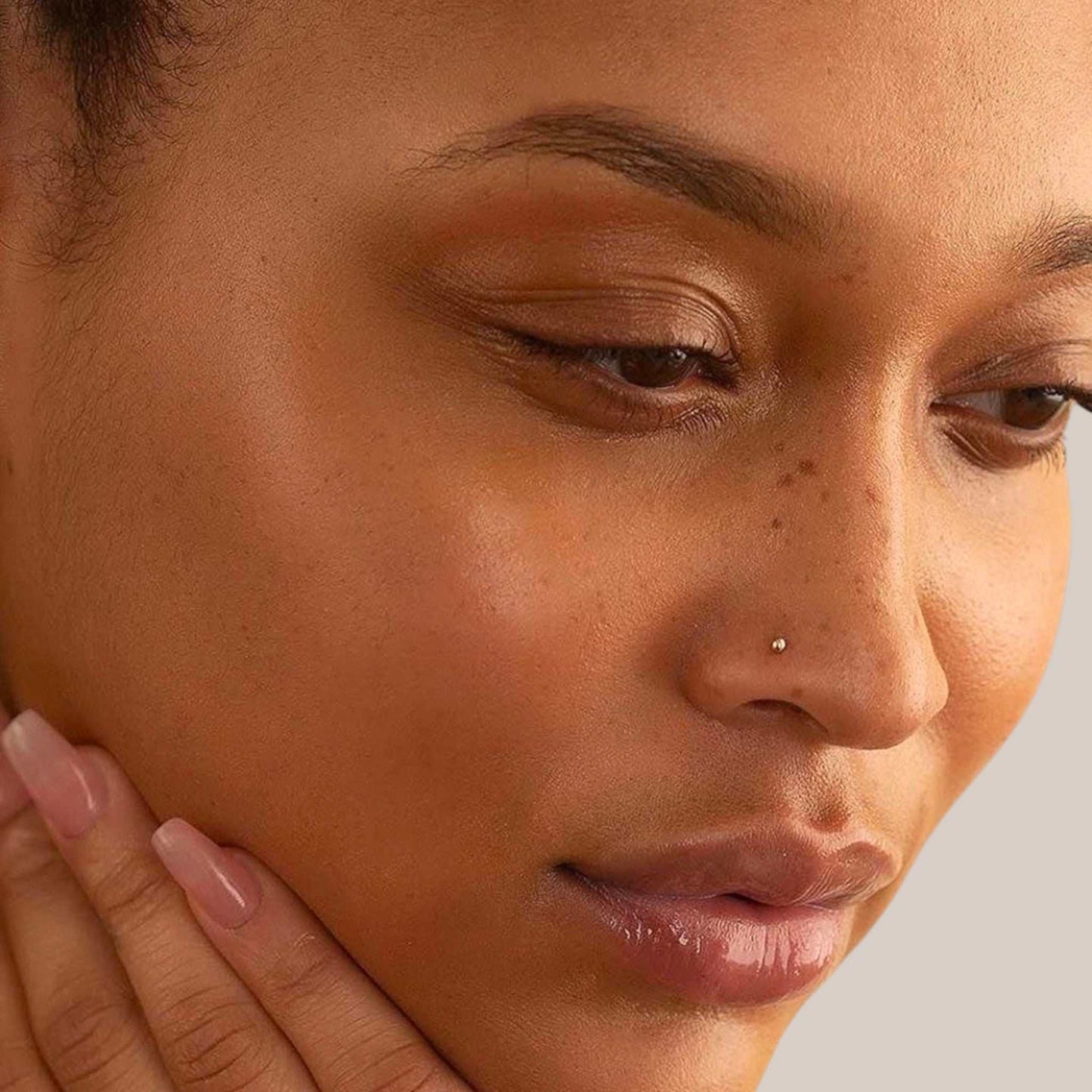 Close-up of a woman's face with a neutral background