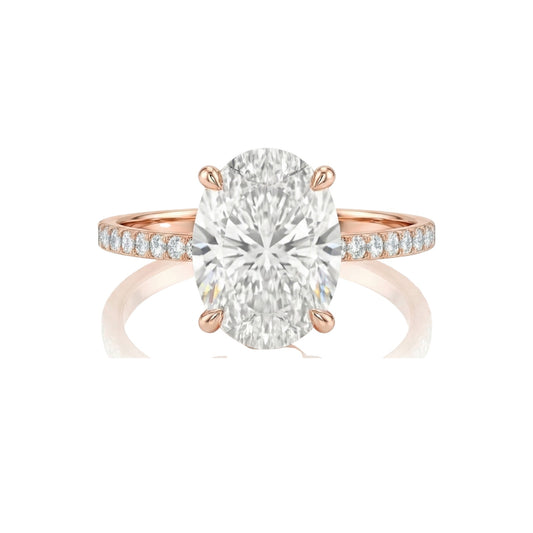 Rose gold ring with a large diamond and smaller diamonds on the band against a white background