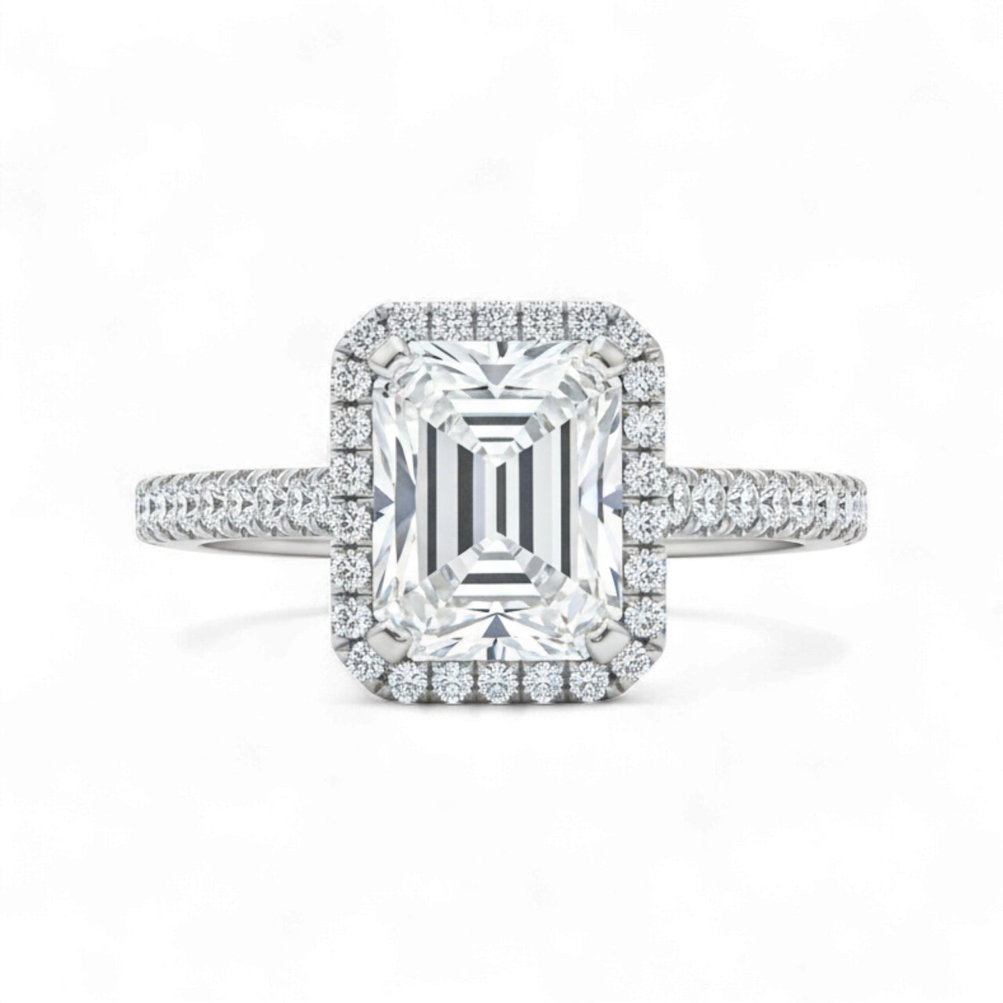 Diamond ring with emerald-cut center stone and halo on a white background