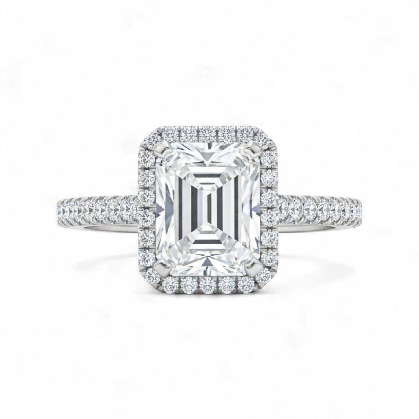 Diamond ring with emerald-cut center stone and halo on a white background