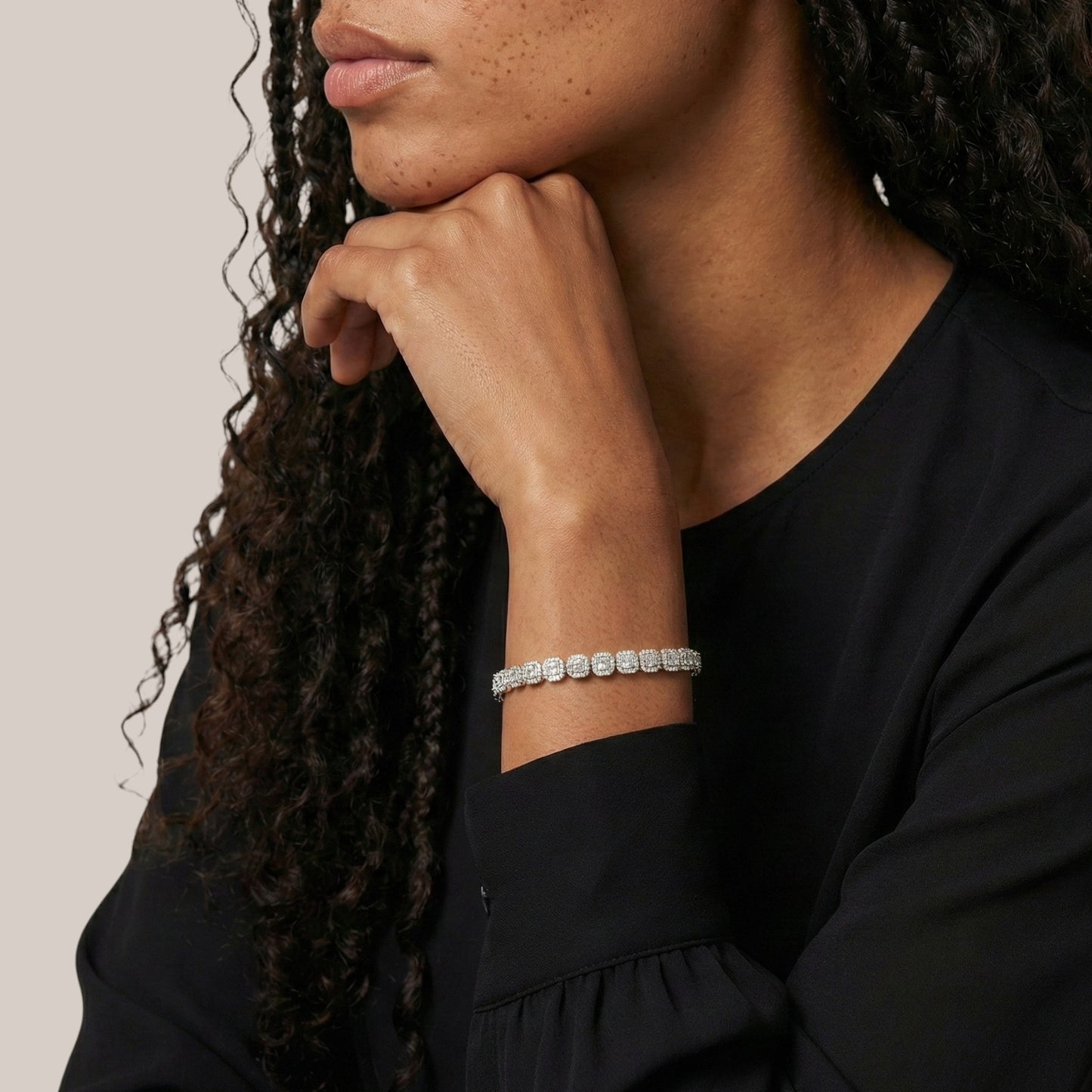 Person wearing a bracelet with a neutral background