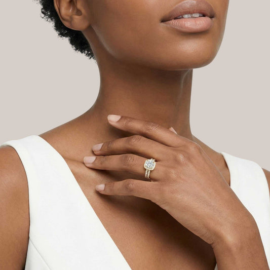 Woman wearing a diamond ring on her hand with a neutral background