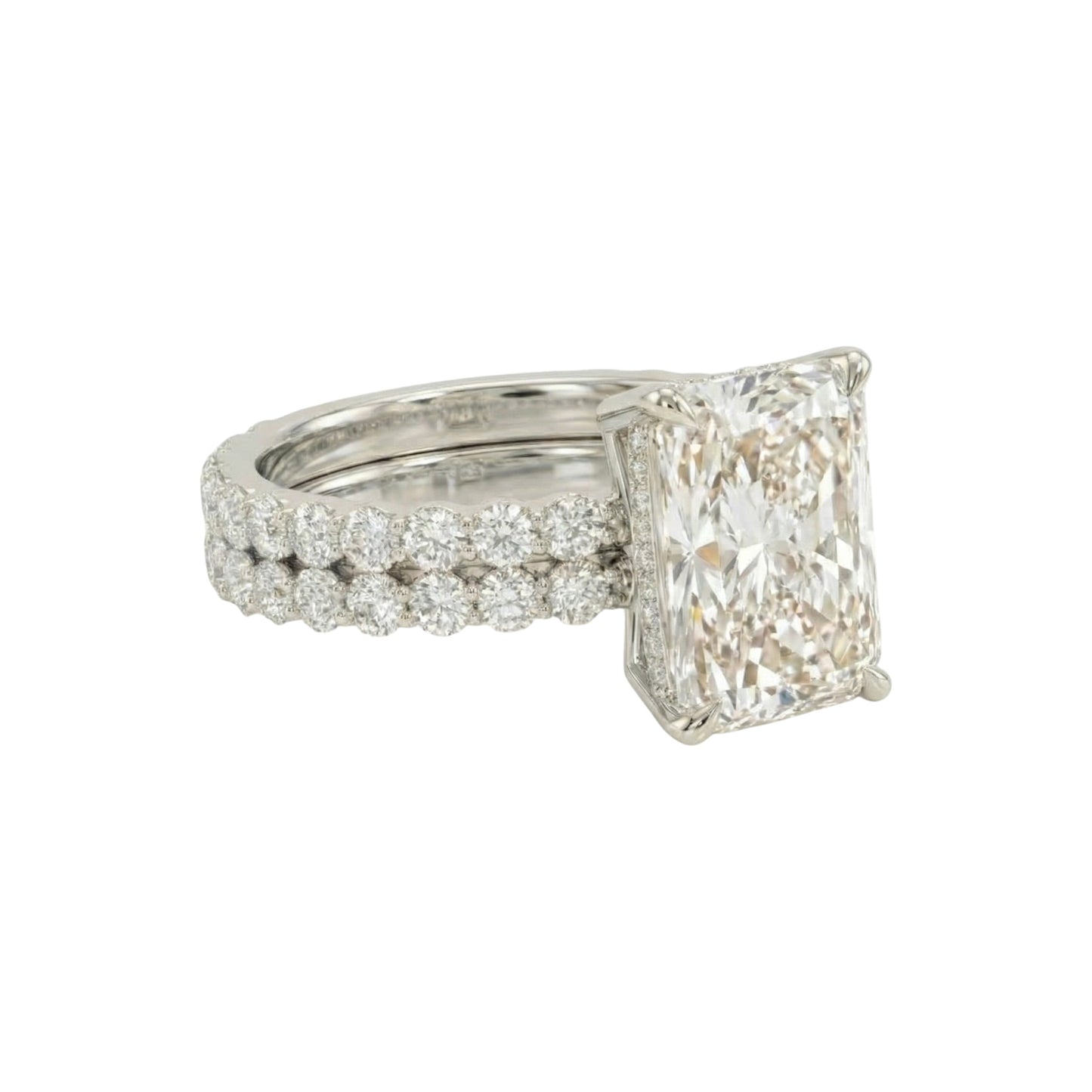 Diamond ring with a large rectangular stone and smaller stones on a white background