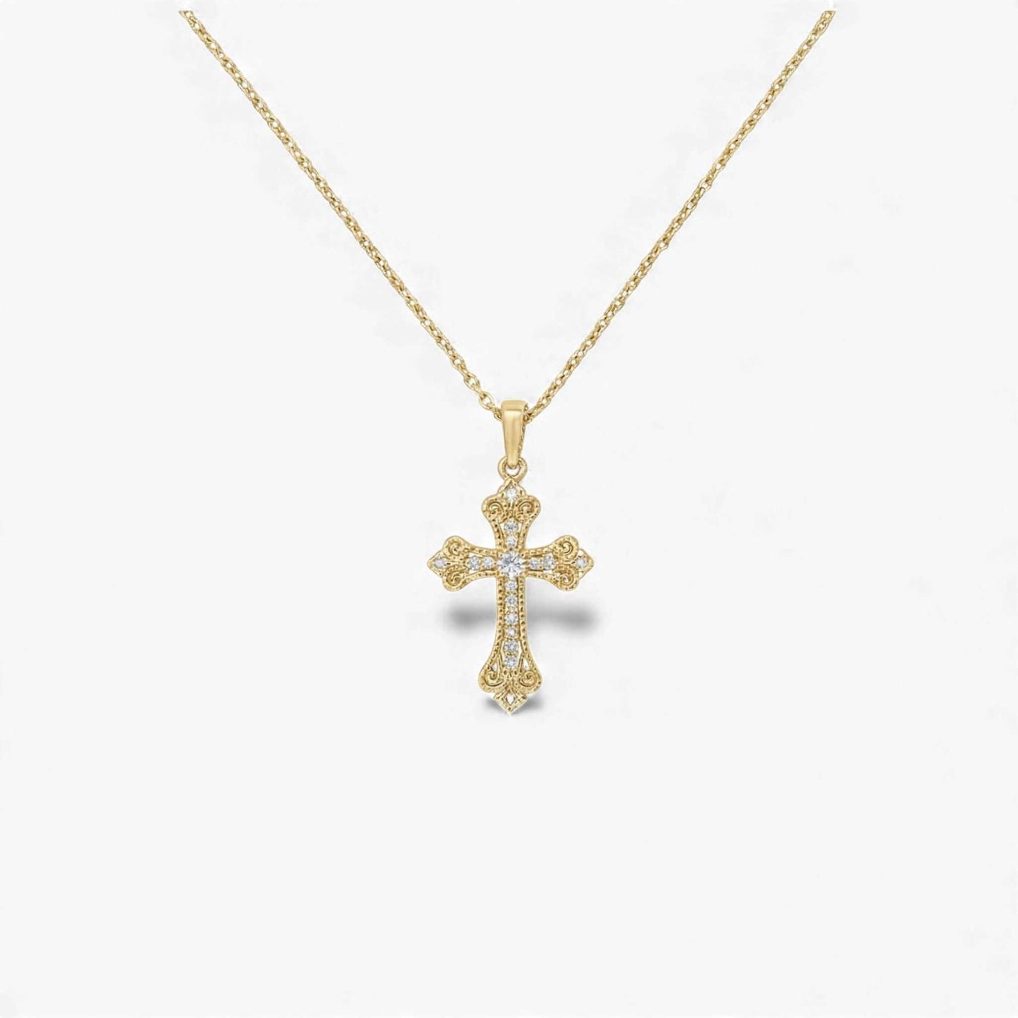 Gold cross pendant necklace on a white background