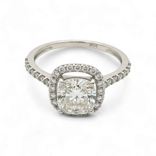 Diamond ring with a cushion-cut center stone and diamond halo on a white background
