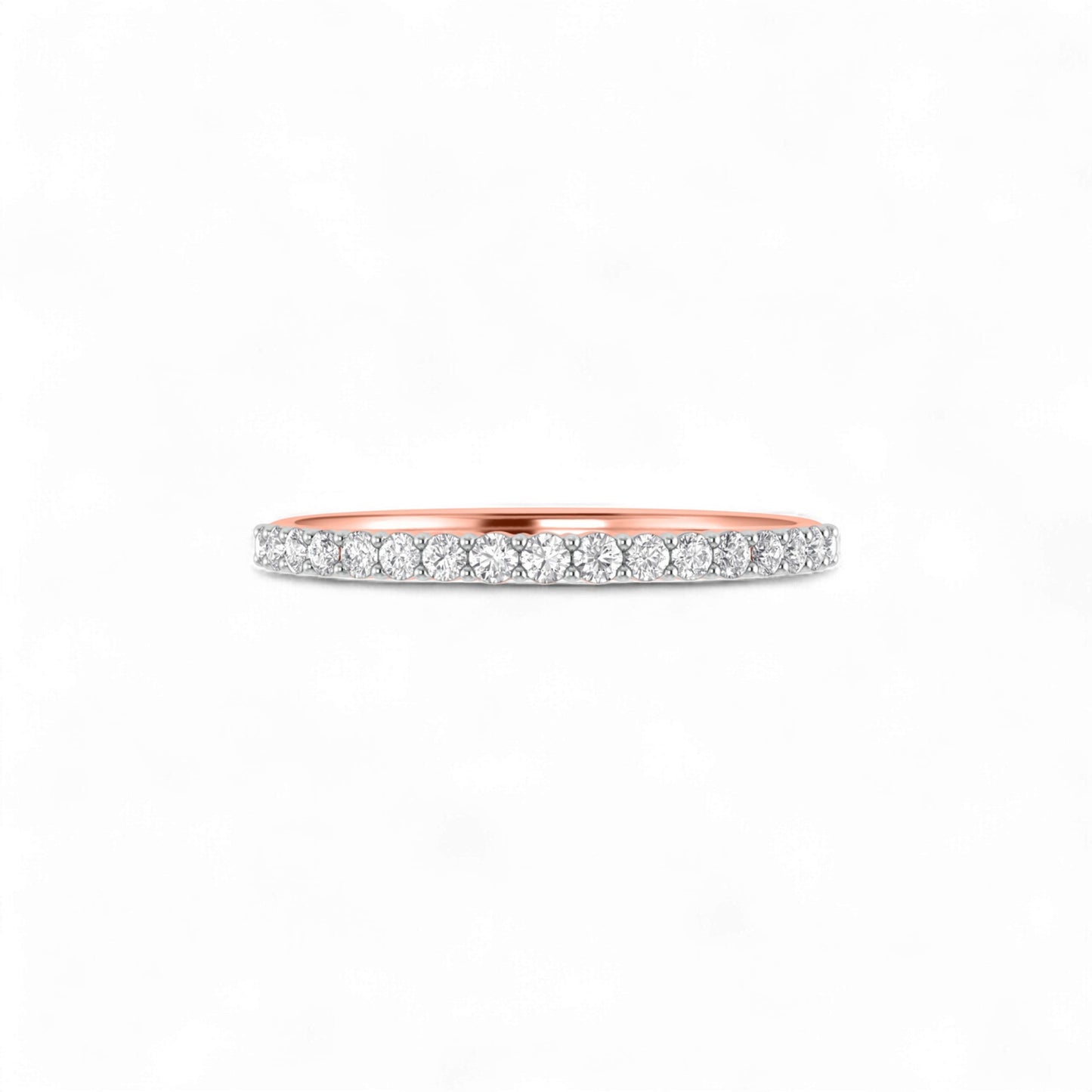 Ring with rose gold band and diamond accents on a white background