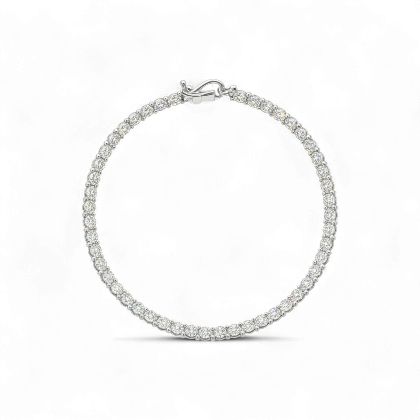 Silver bracelet with clear stones on a white background
