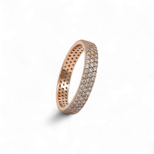 Rose gold ring with embedded stones on a white background