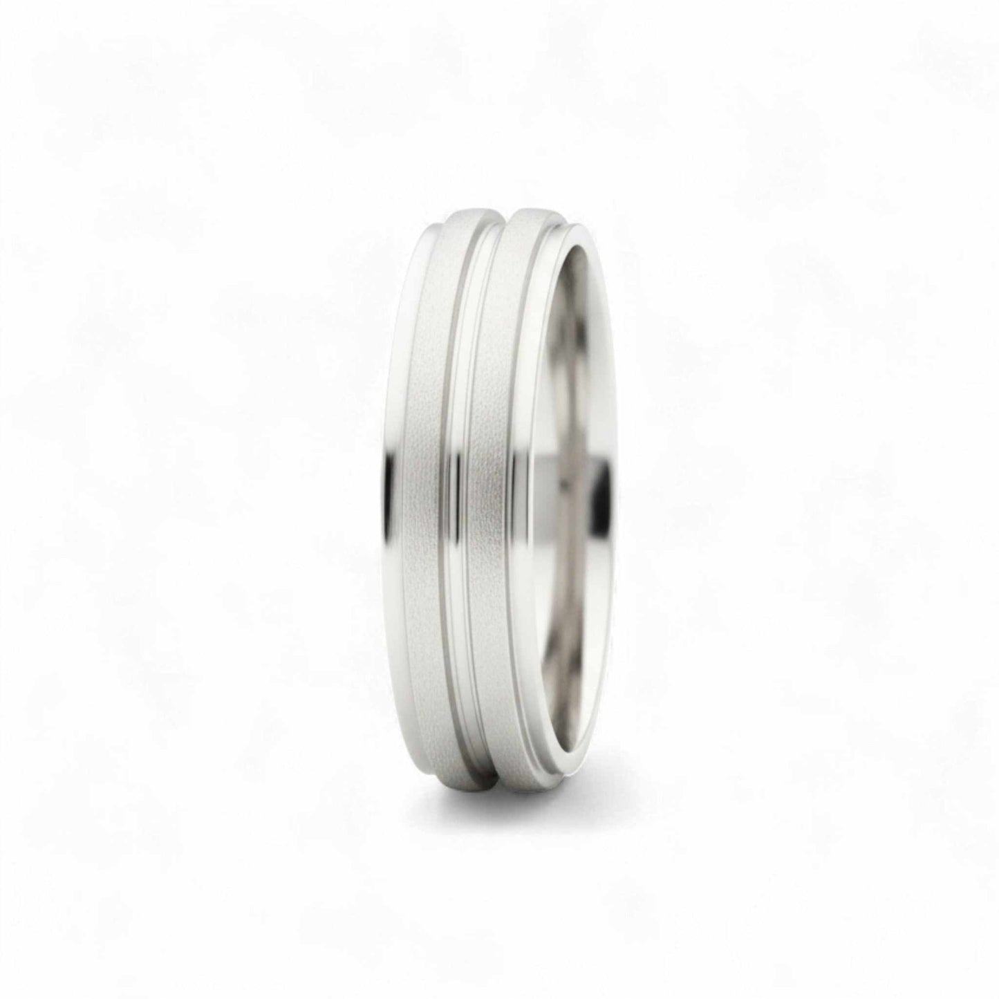 Silver ring with a textured band on a white background