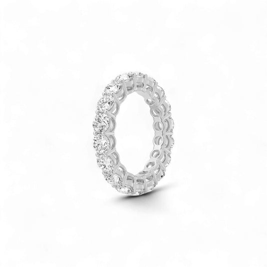 Silver ring with intricate design on a white background