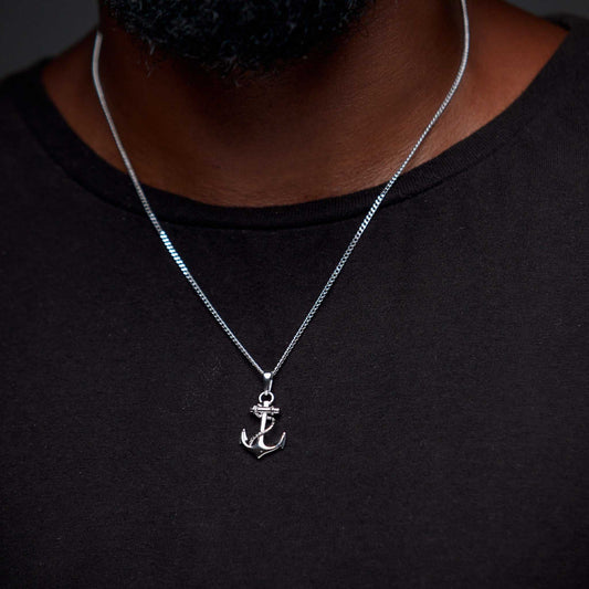 Silver anchor necklace on a black shirt