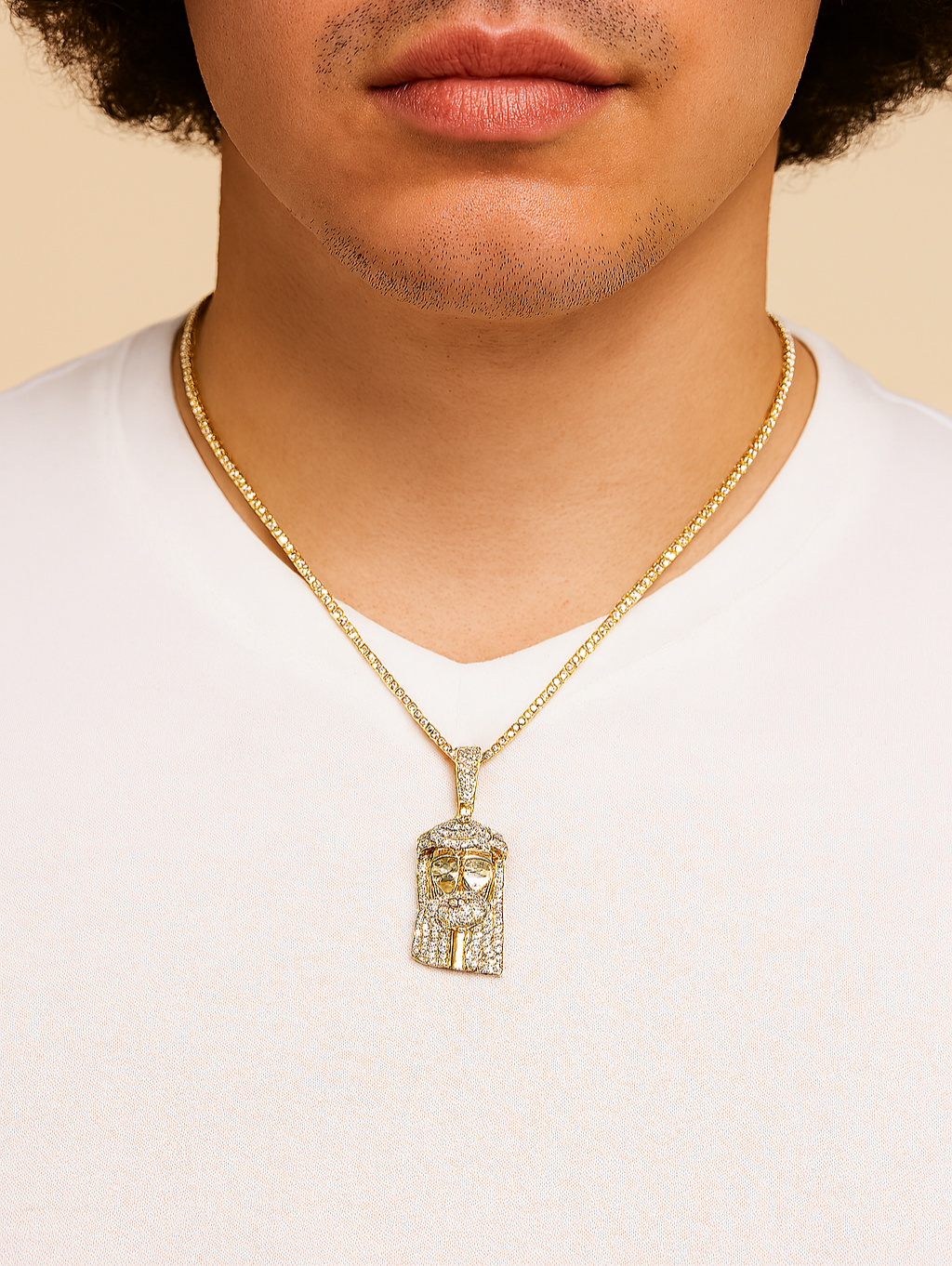 Man wearing a gold necklace with a lion pendant on a beige background