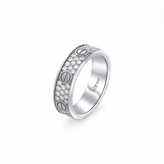 Silver ring with engraved symbols on a white background