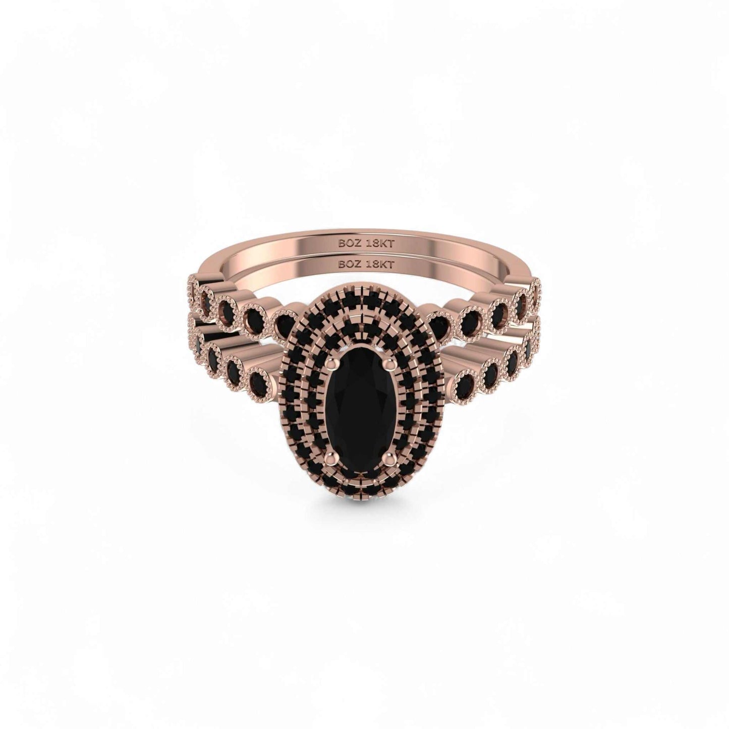 Rose gold ring with black gemstones on a white background