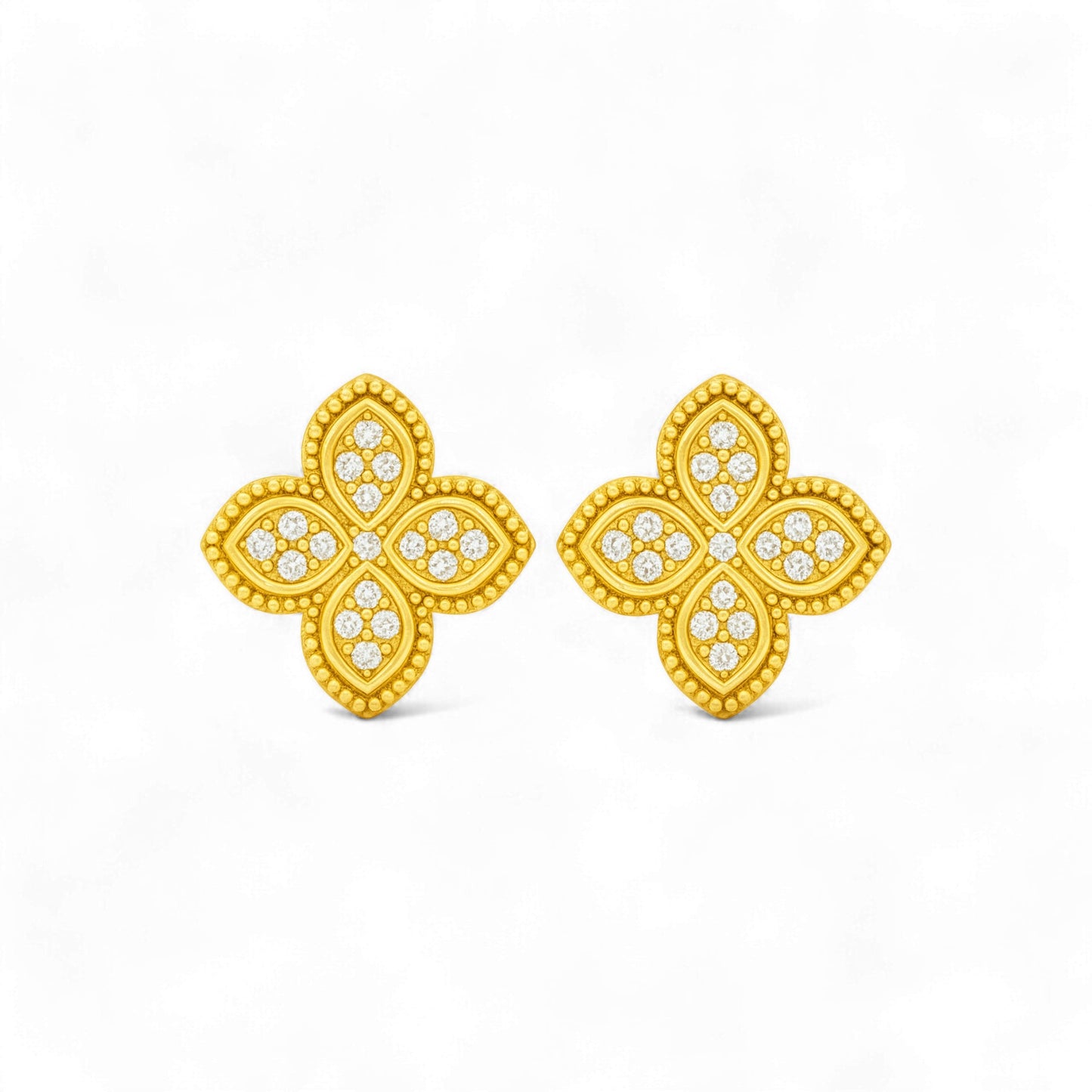 Gold butterfly earrings with diamond-like stones on a white background