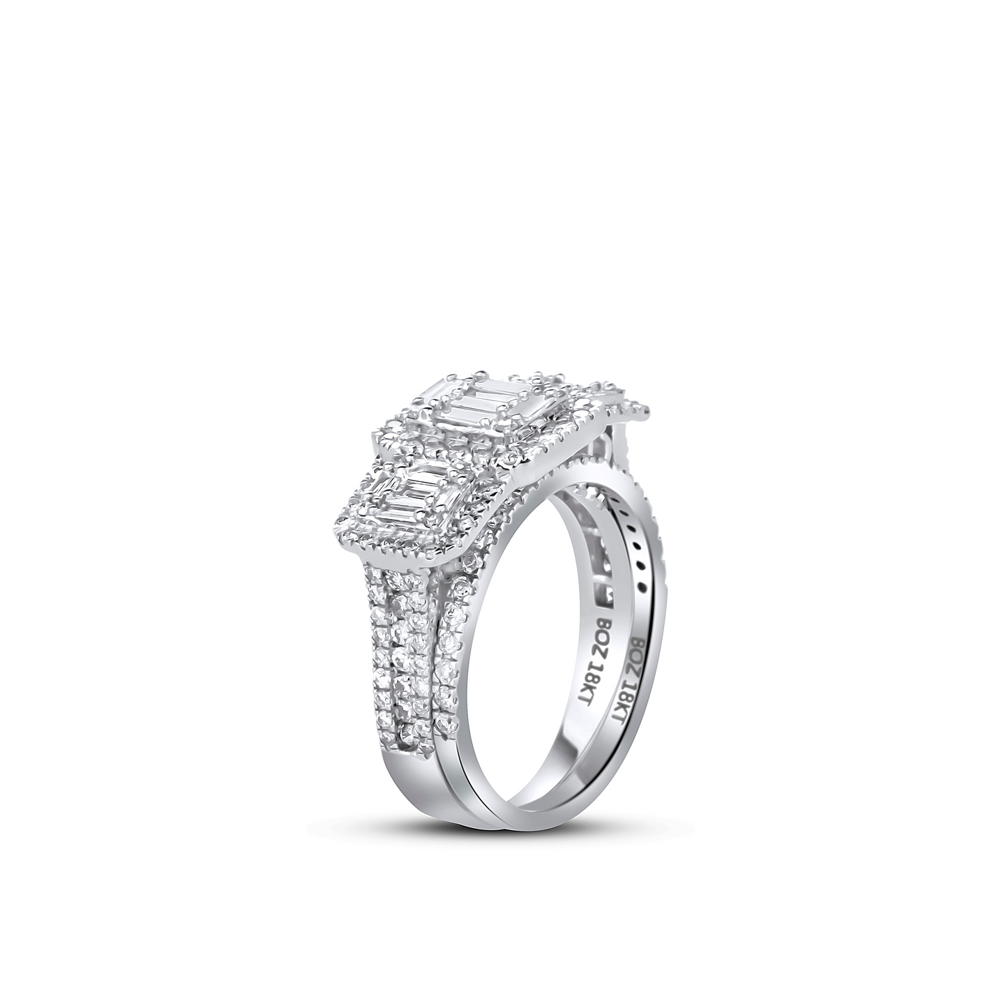Diamond ring with emerald-cut center stone on a white background