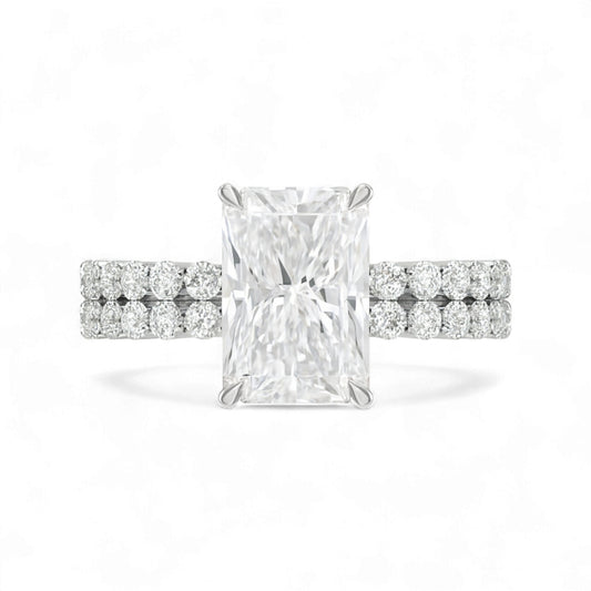 Diamond ring with a rectangular center stone on a white background