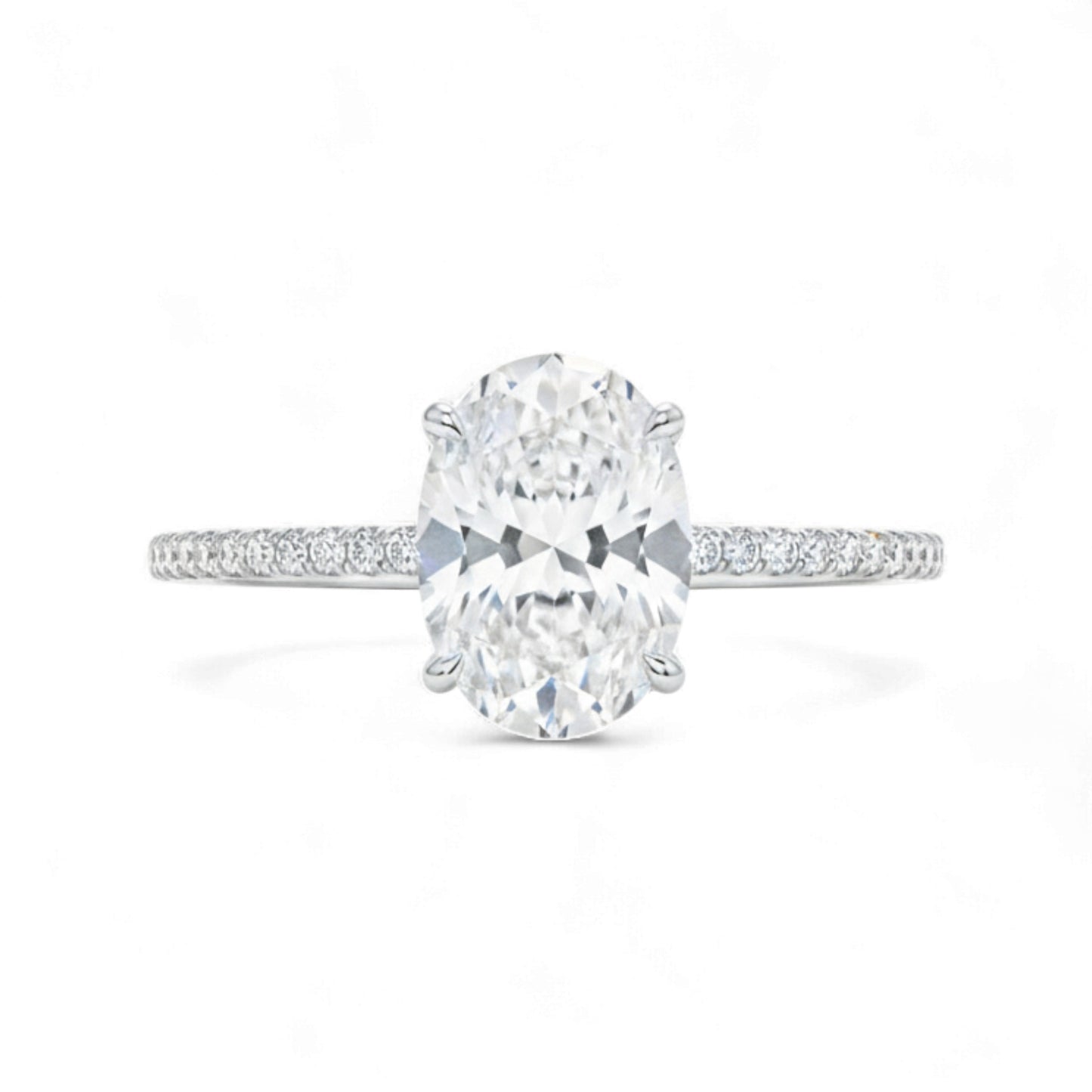 Diamond ring with a large central gemstone and smaller stones on the band against a white background