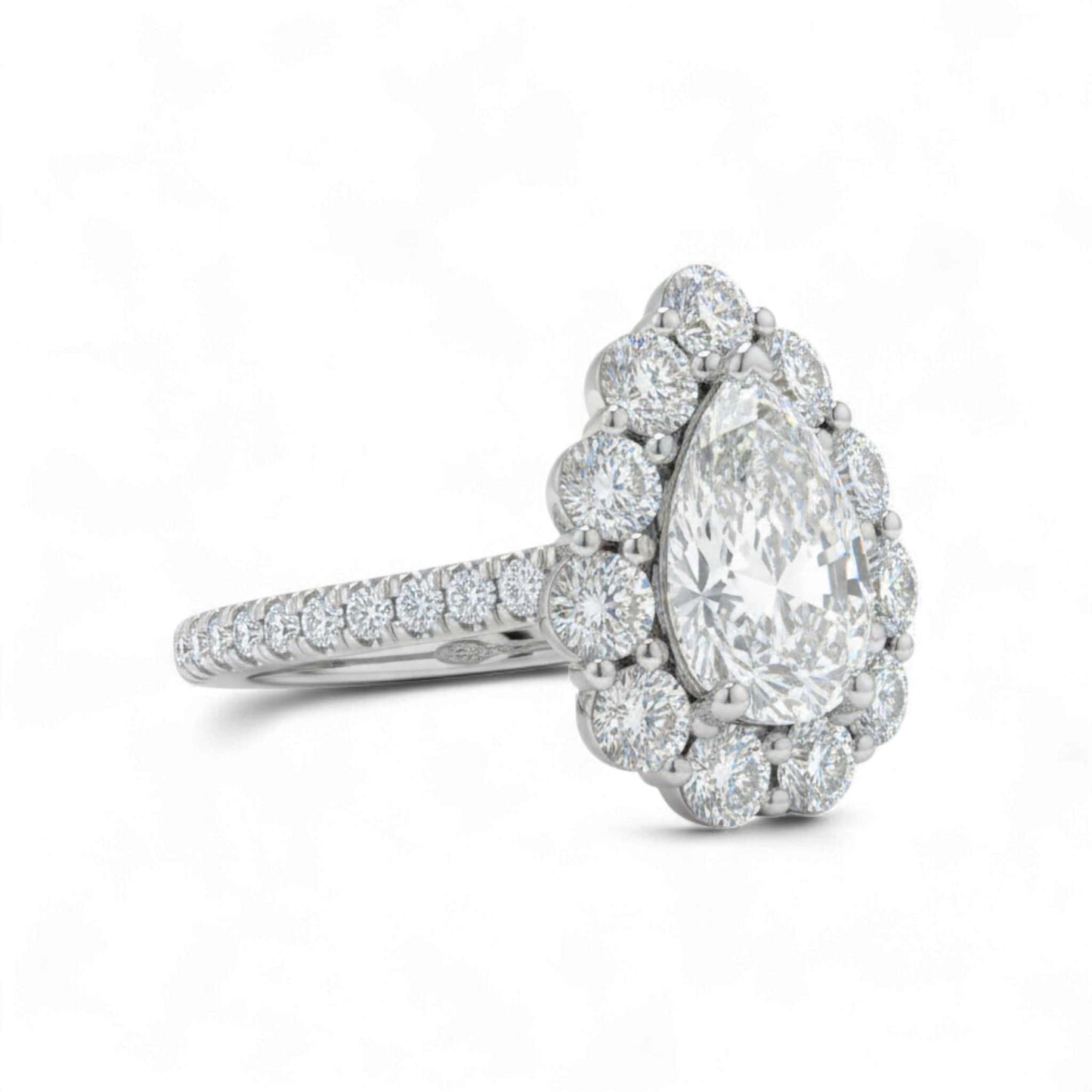 Diamond ring with a pear-shaped center stone on a white background
