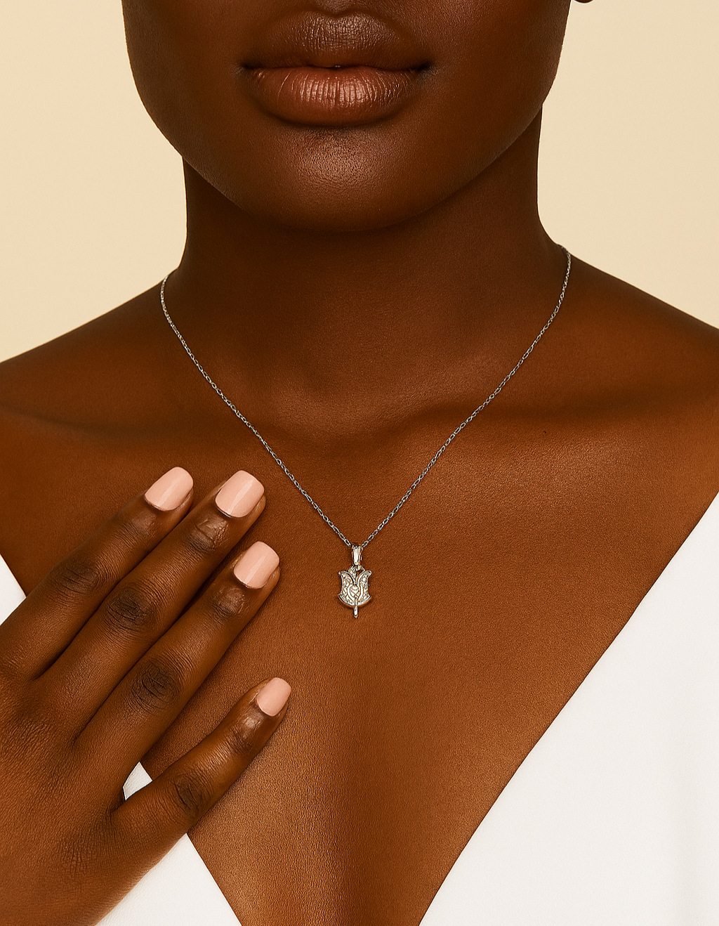 Necklace with a pendant on a model against a beige background
