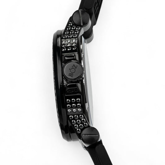 Close-up of a black wristwatch with detailed design on a white background