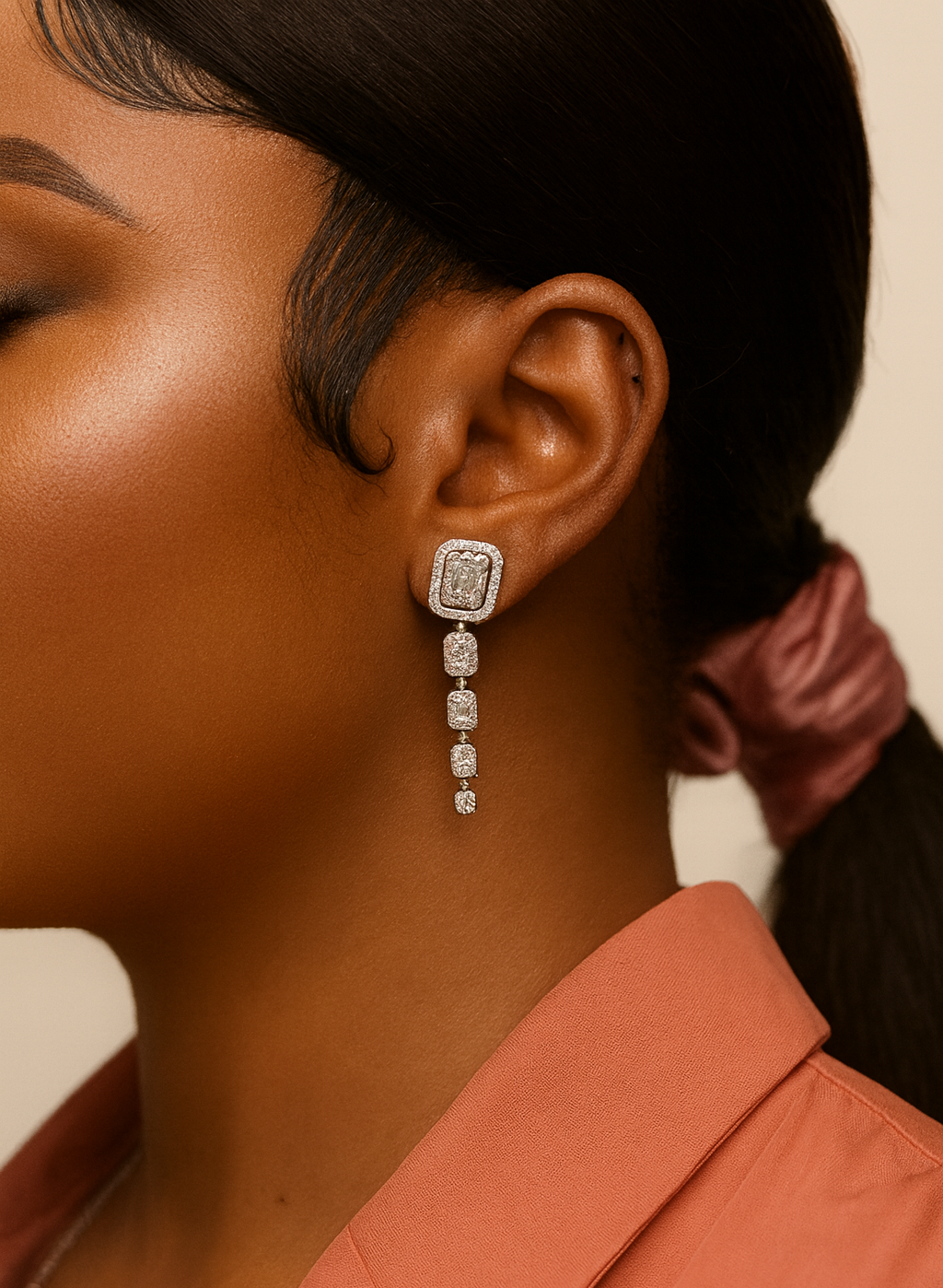 Close-up of a person wearing a diamond earring with a blurred background