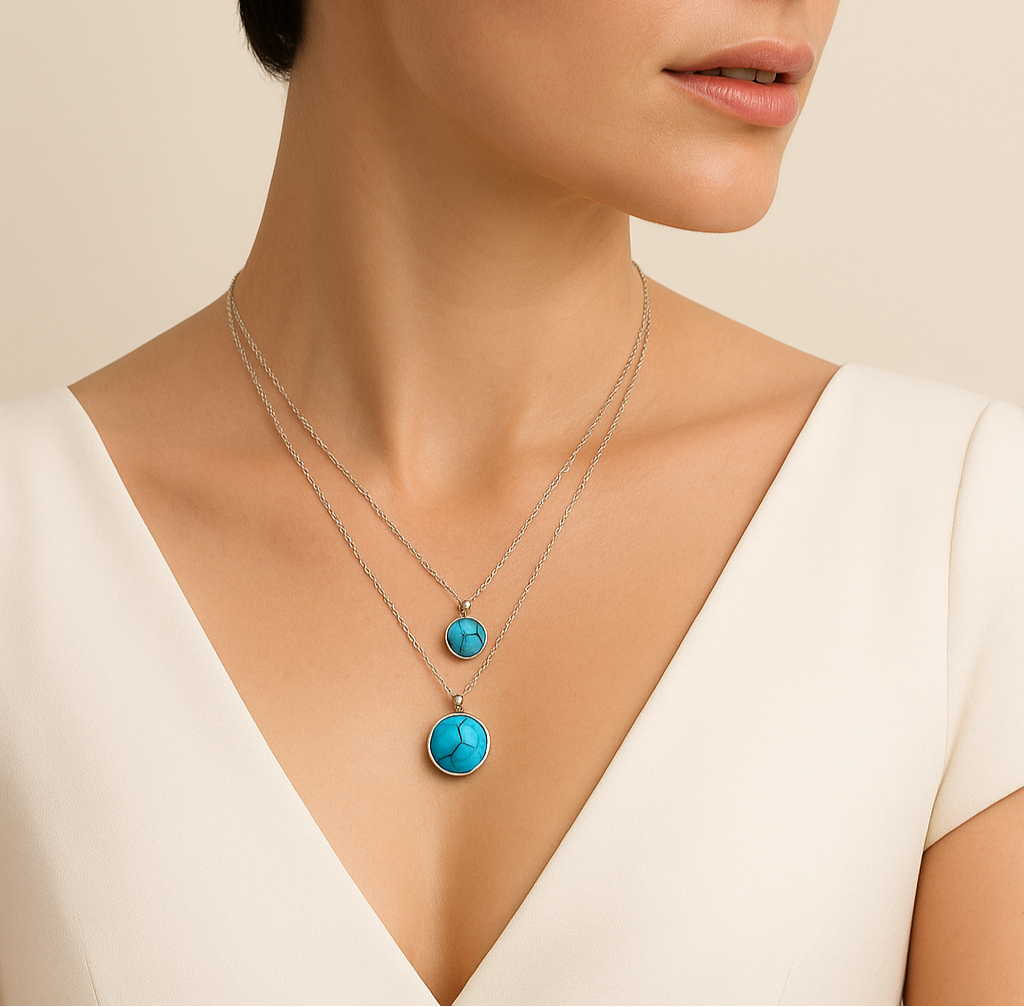 Woman wearing a necklace with turquoise pendants against a beige background