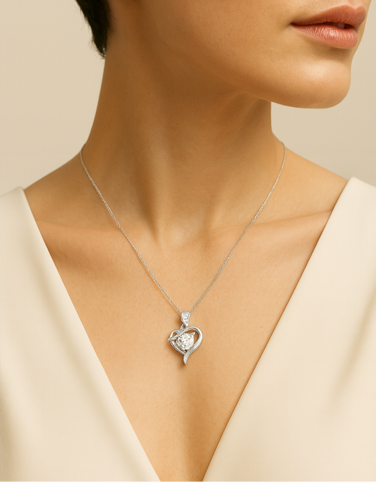 Close-up of a woman wearing a silver heart-shaped necklace against a beige background