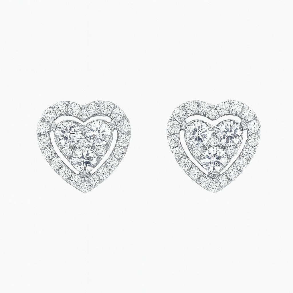 Heart-shaped earrings with clear gemstones on a white background