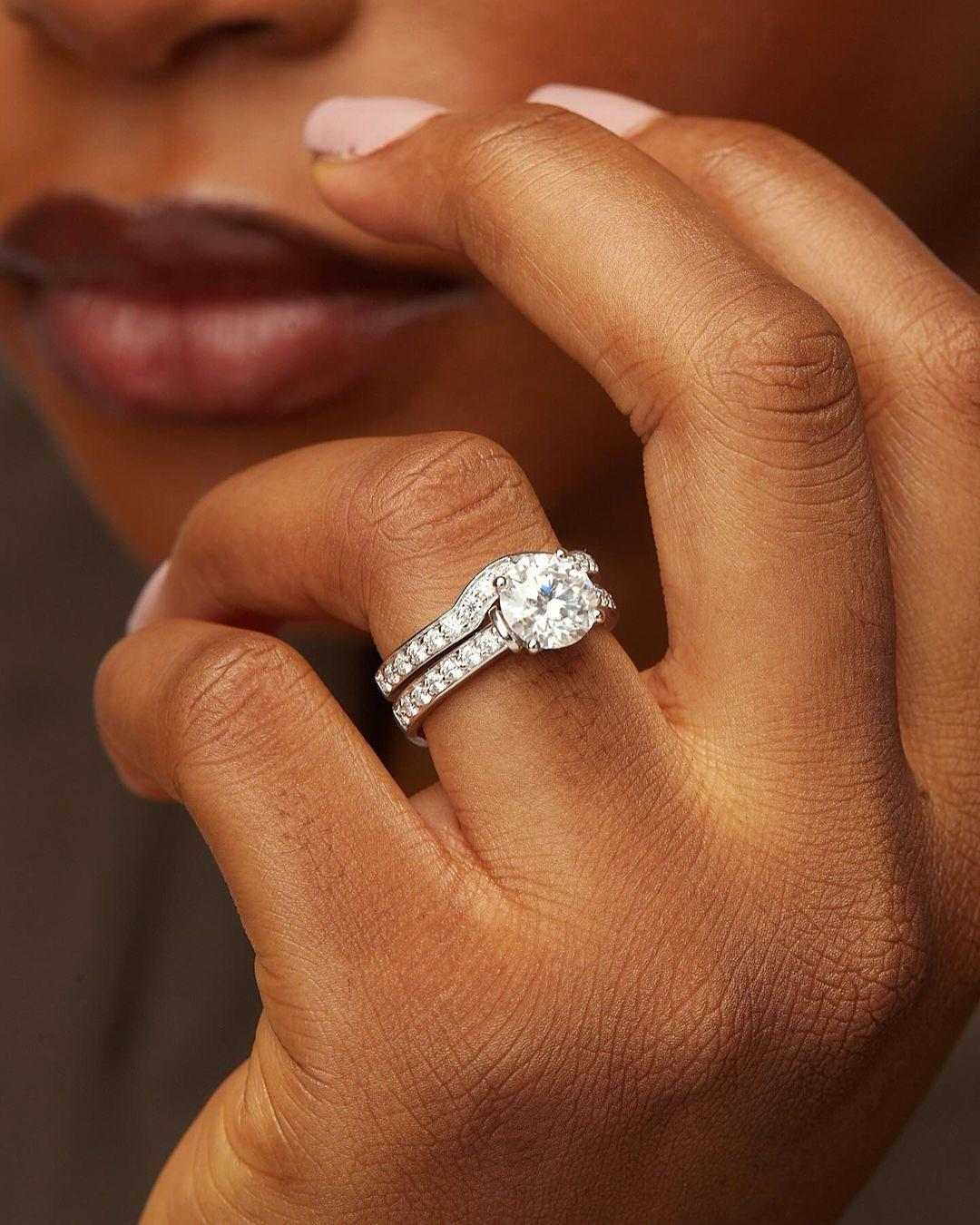 Evermore Round Moissanite bridal set in 18K gold featuring a round-cut moissanite and diamond-studded bands