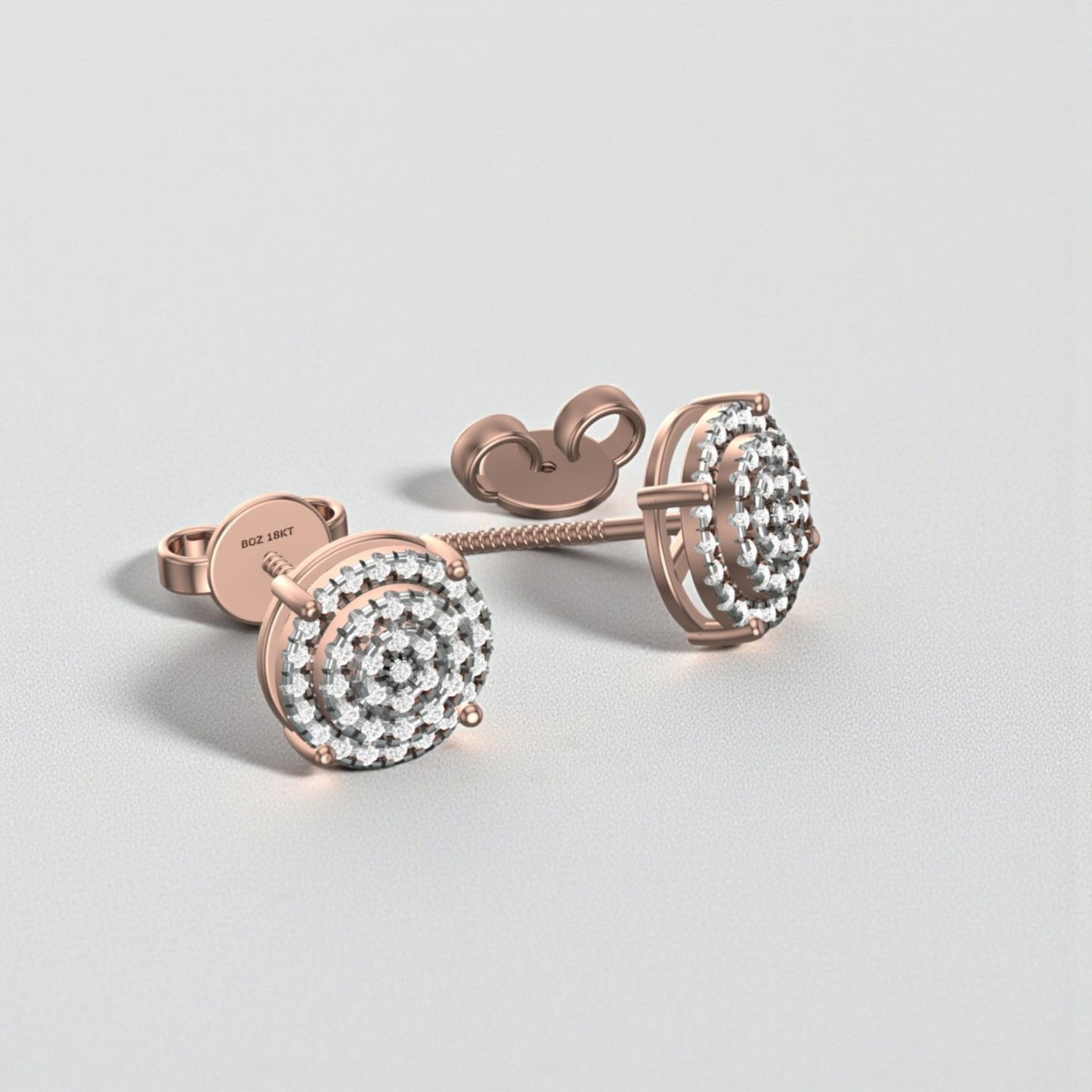 Rose gold earrings with clear gemstones on a light gray background