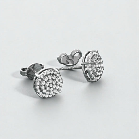 Pair of silver earrings with clear gemstones on a light gray background