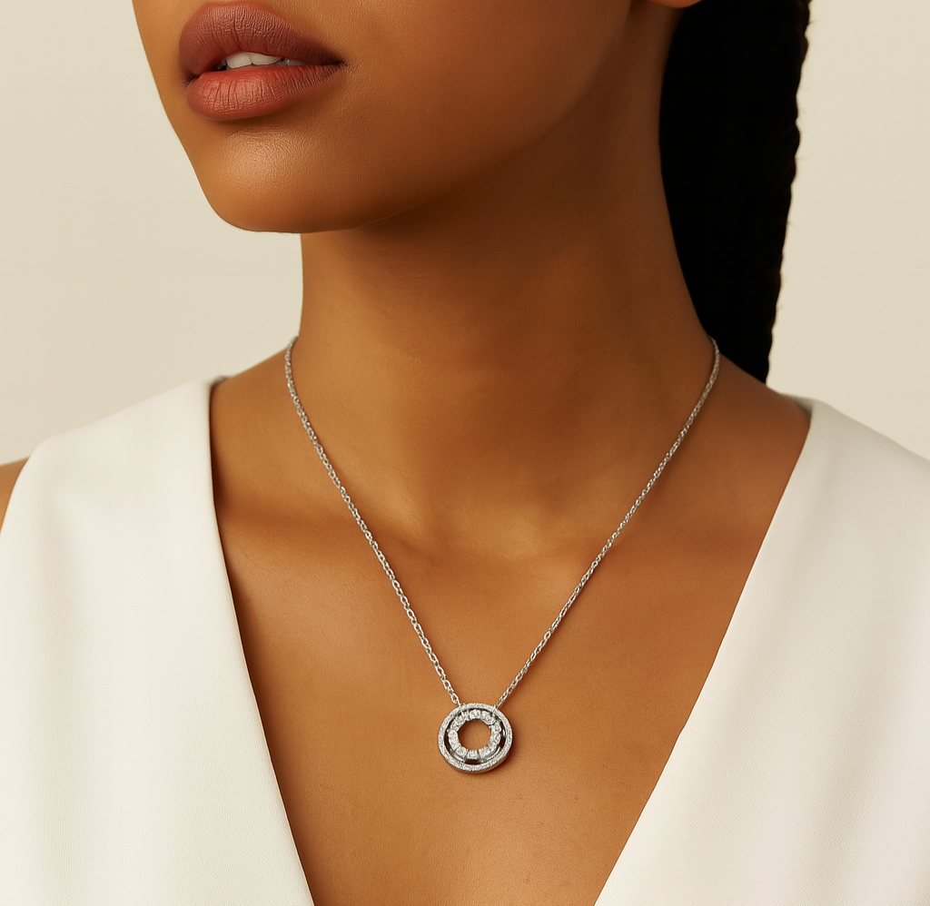 Woman wearing a silver necklace with a circular pendant on a beige background