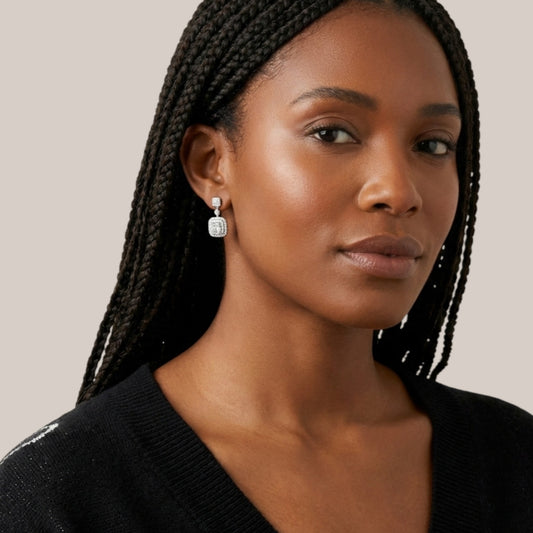 Woman wearing earrings with a neutral background