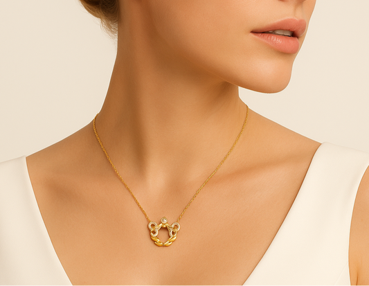Woman wearing a gold necklace against a beige background