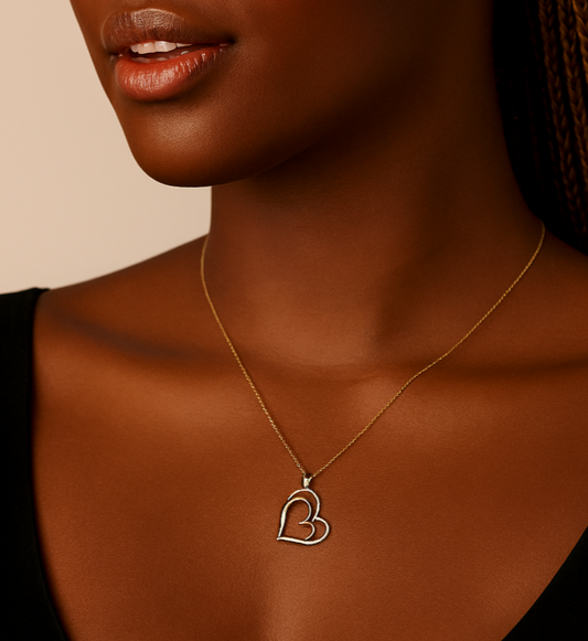 Woman wearing a necklace with a heart pendant, branded as BOZ Jewelry.