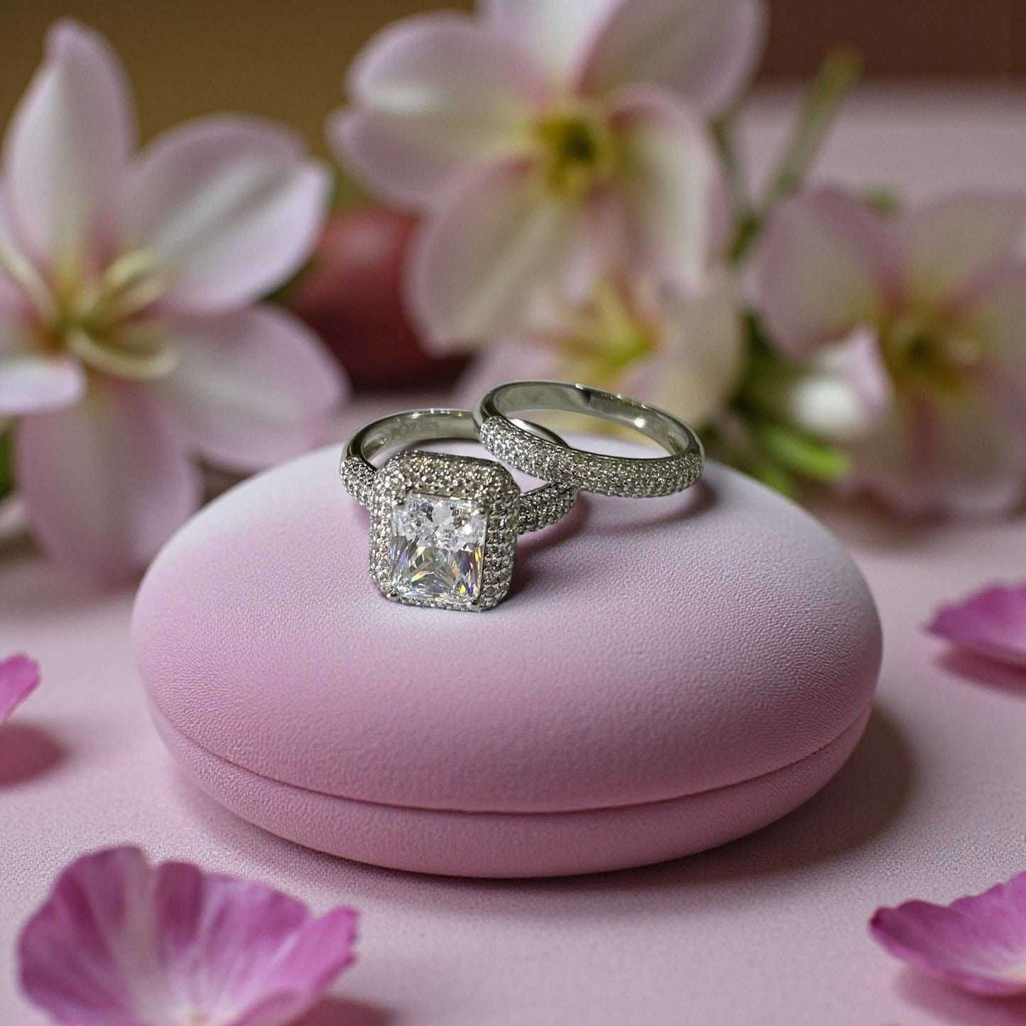 Zara Princes Cut CZ Bride Set in 925 sterling silver with princess cut cubic zirconia and halo design on pink cushion with flowers