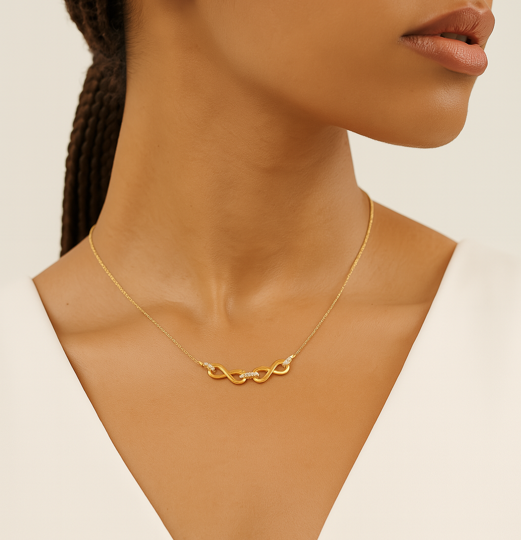 Gold necklace on a model with a neutral background