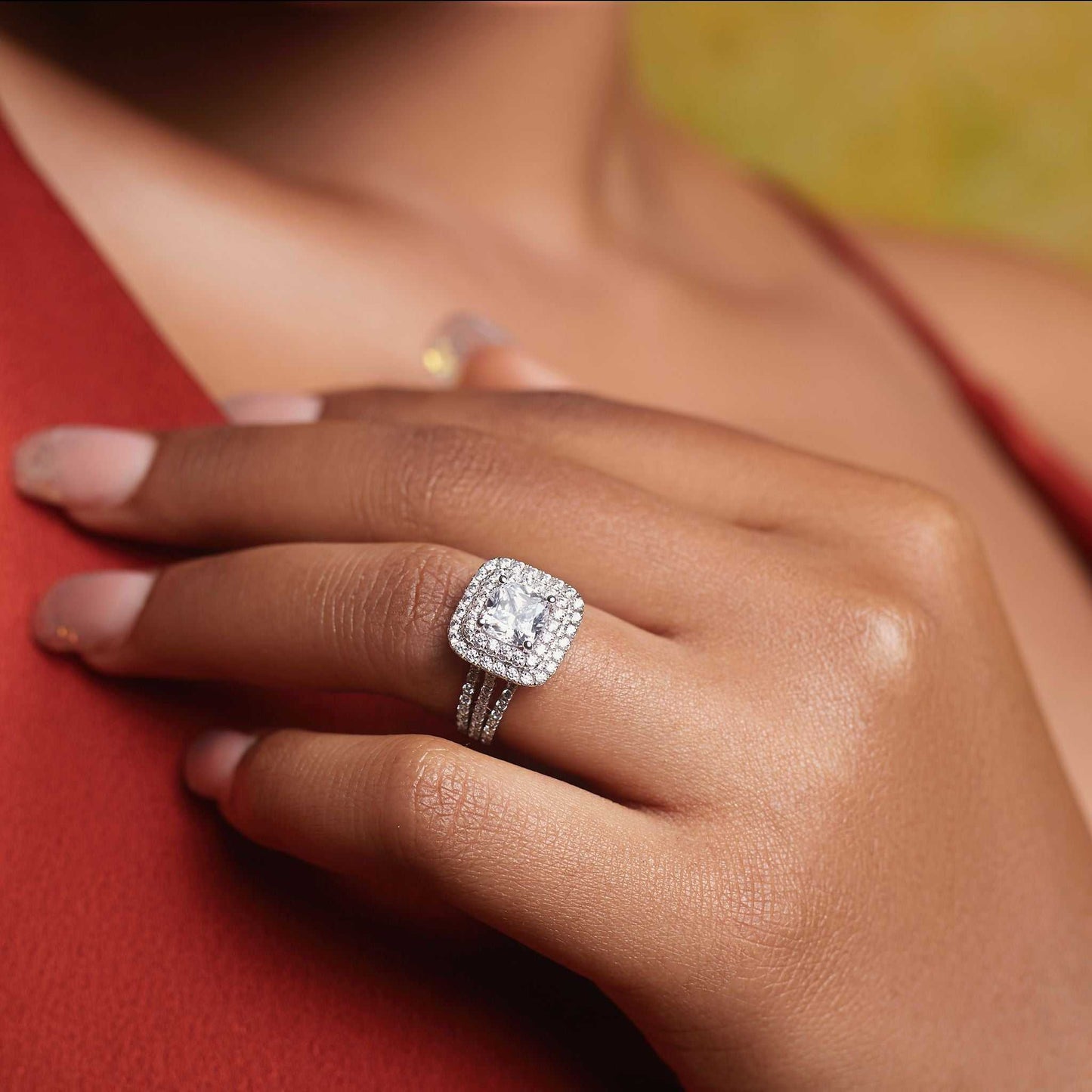 Lovely CZ princess cut sterling silver engagement ring on hand with sparkling cubic zirconia centerpiece and polished band