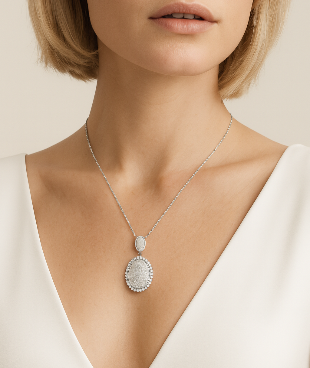 Woman wearing a necklace with a pendant on a plain background