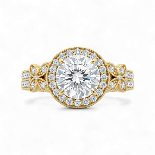 Gold ring with a large diamond and smaller diamonds on the band against a white background