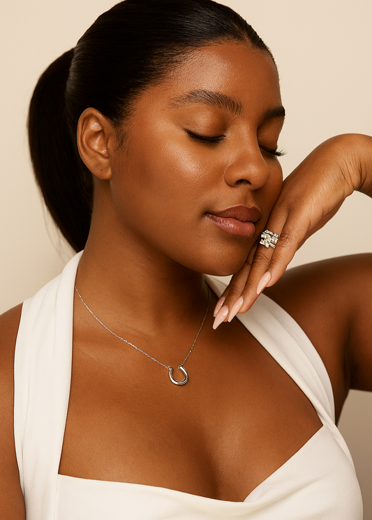 Woman wearing a necklace with a minimal background