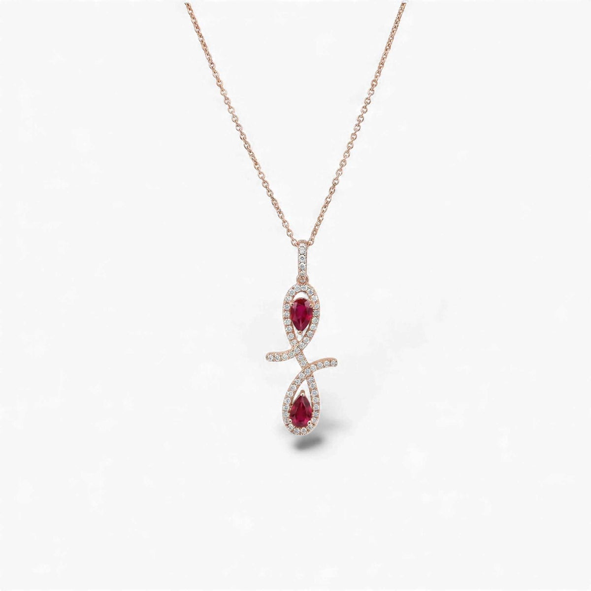 Rose gold necklace with a red gemstone pendant on a white background