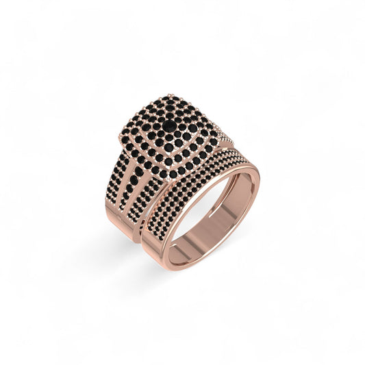 Rose gold ring with black gemstones on a white background