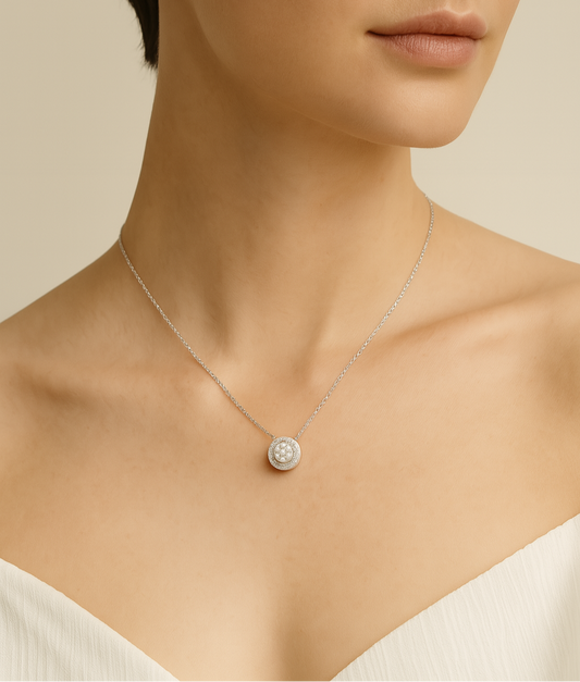 Necklace with a round pendant worn by a model on a neutral background