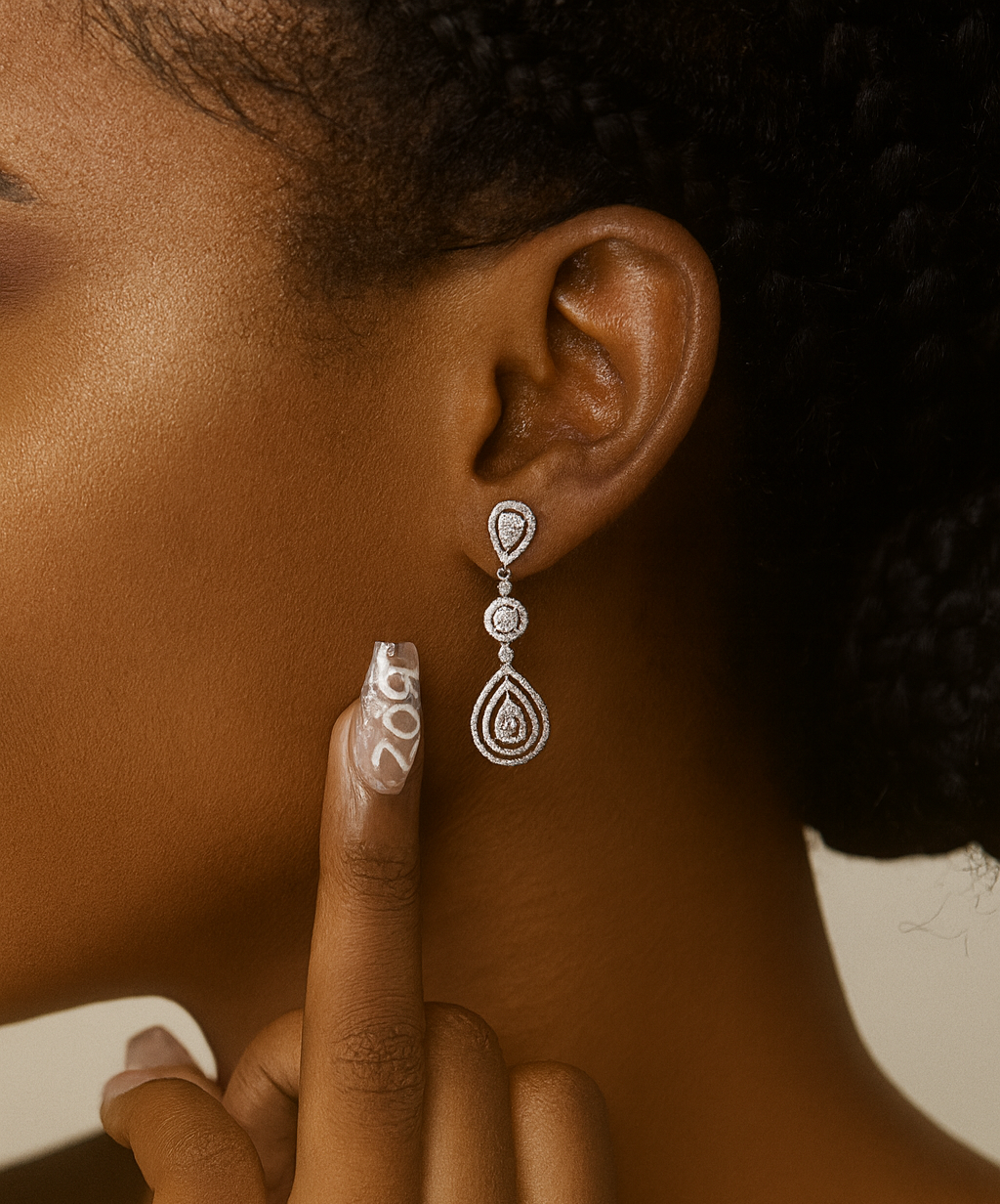 Close-up of a person wearing a silver earring with a blurred background